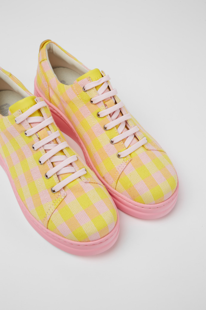 Close-up view of Runner Up Yellow and pink recycled cotton sneakers for women