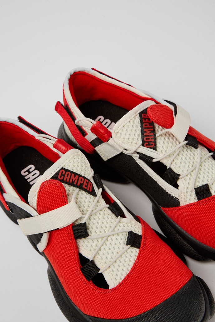 Close-up view of Karst White, black, and red textile shoes for women