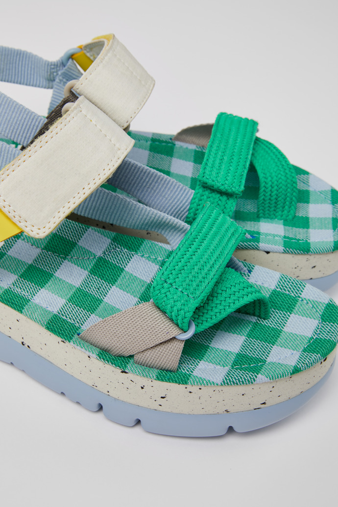 Close-up view of Oruga Up Blue, green, and grey sandals for women