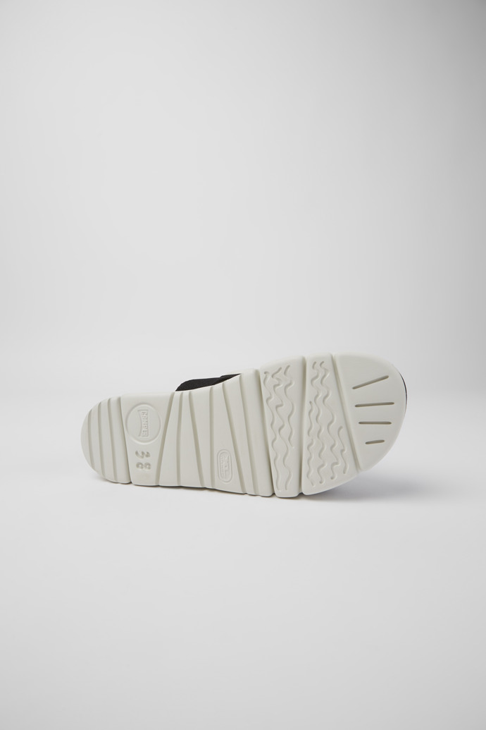 The soles of Oruga Up White, blue, and black sandals for women