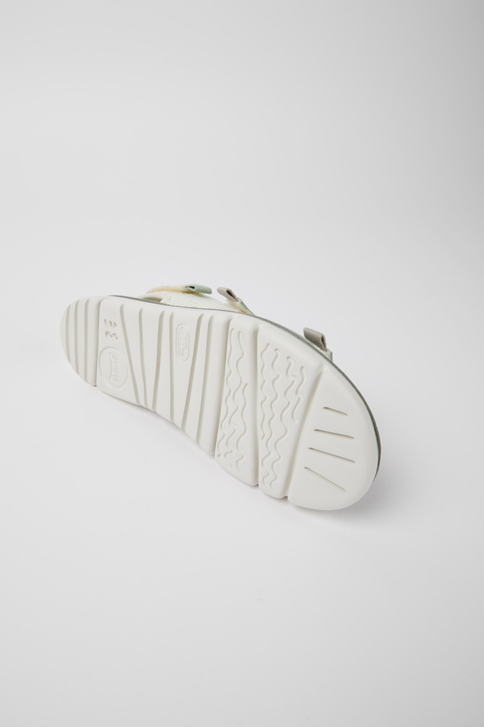 The soles of Oruga White, green, and grey sandals for women