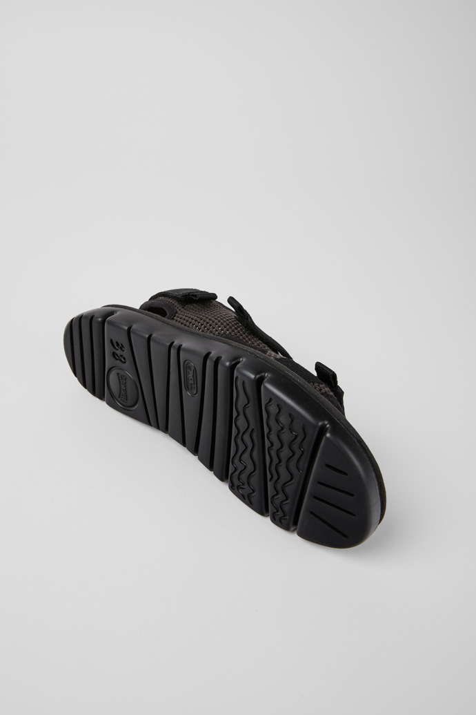 The soles of Oruga Black and grey sandals for women