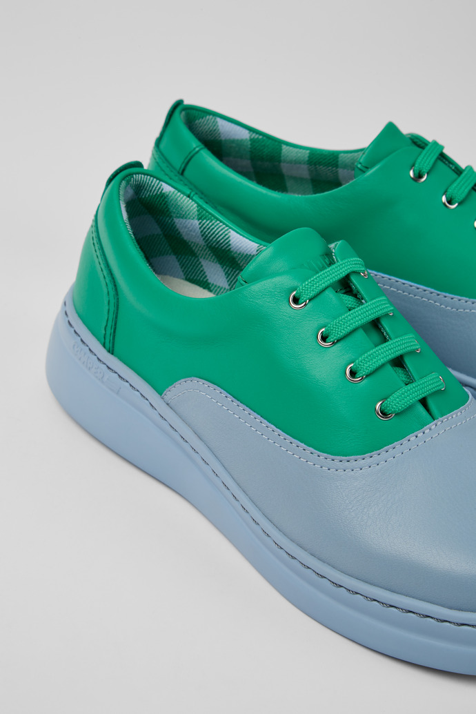 Close-up view of Runner Up Blue and green leather sneakers for women