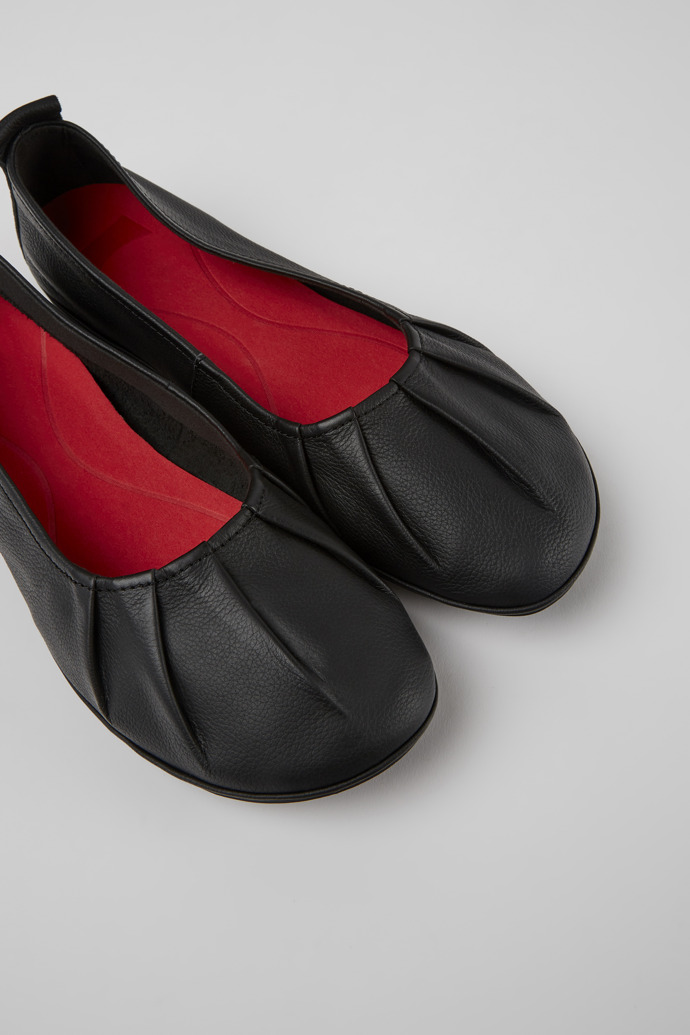 Close-up view of Right Black leather ballerina flats for women