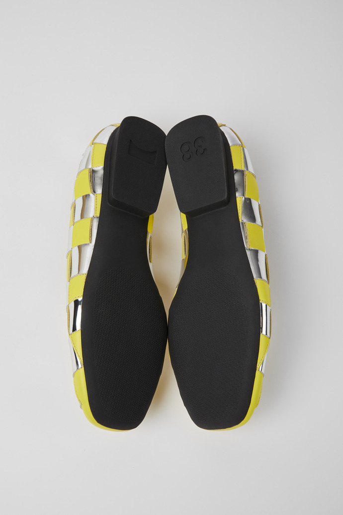 The soles of Casi Myra Yellow and silver shoes for women