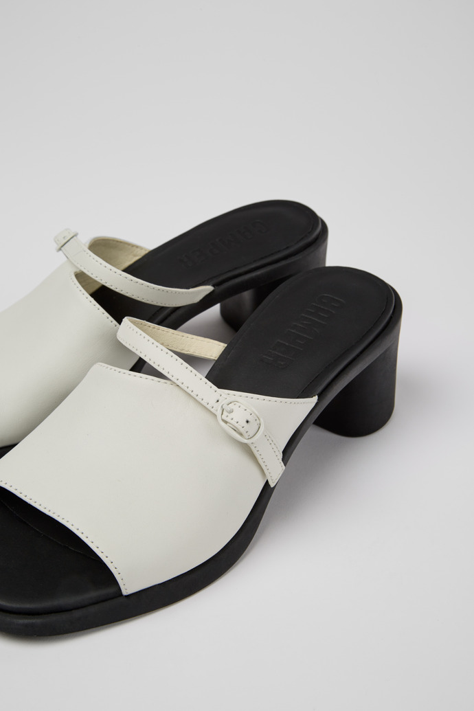 Close-up view of Meda White and black leather sandals for women