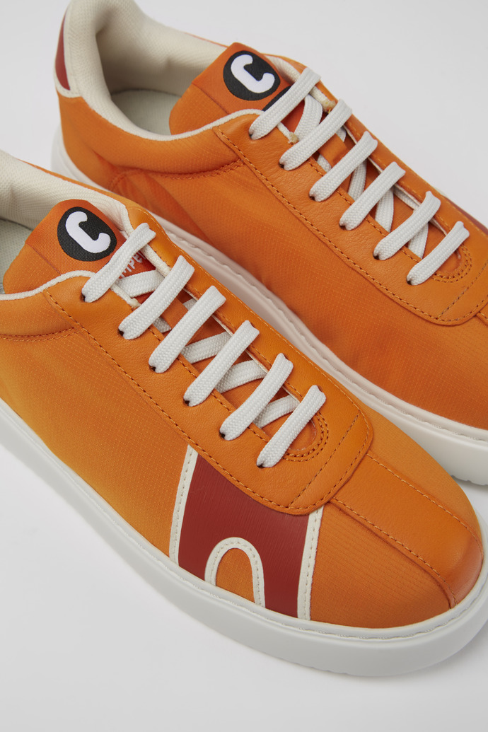 Close-up view of Runner K21 Orange and red sneakers for women