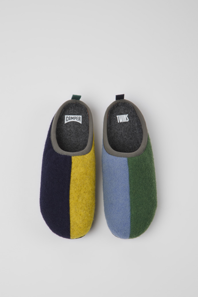 Overhead view of Twins Blue, yellow, and green wool slippers for women
