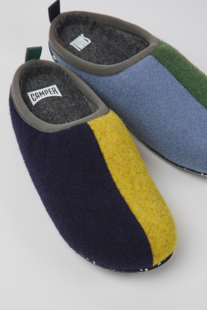 Close-up view of Twins Blue, yellow, and green wool slippers for women