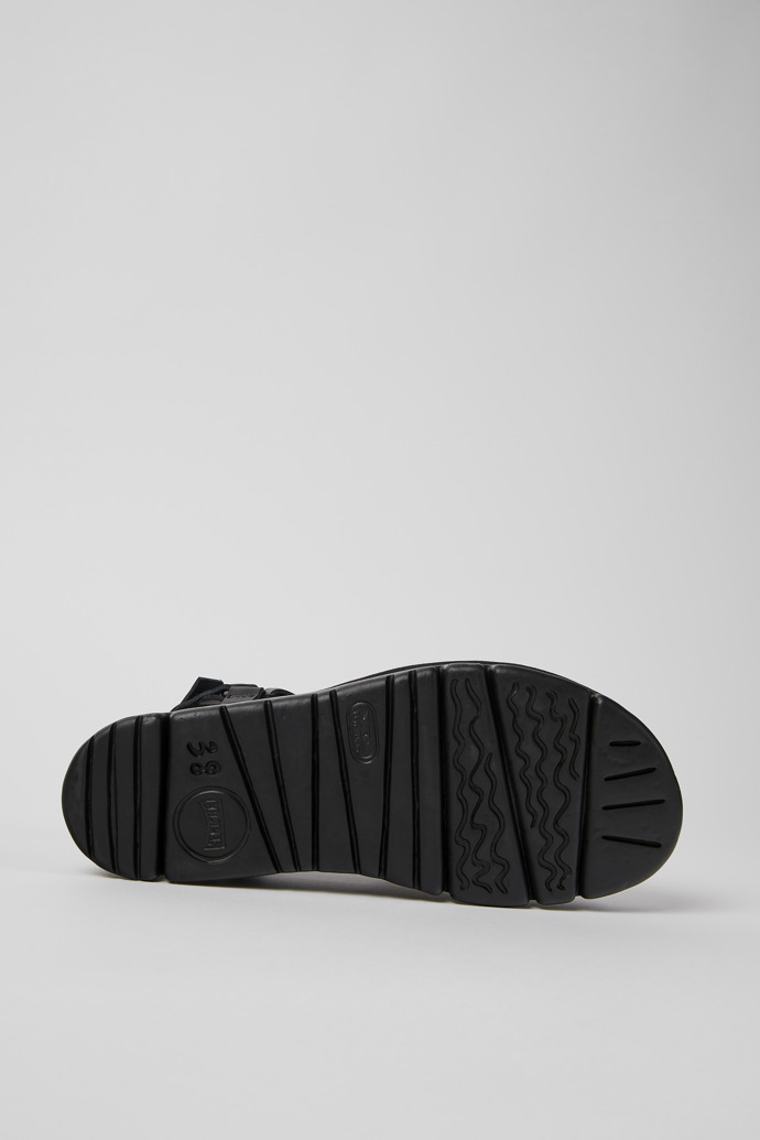 The soles of Oruga Up Black leather sandals for women