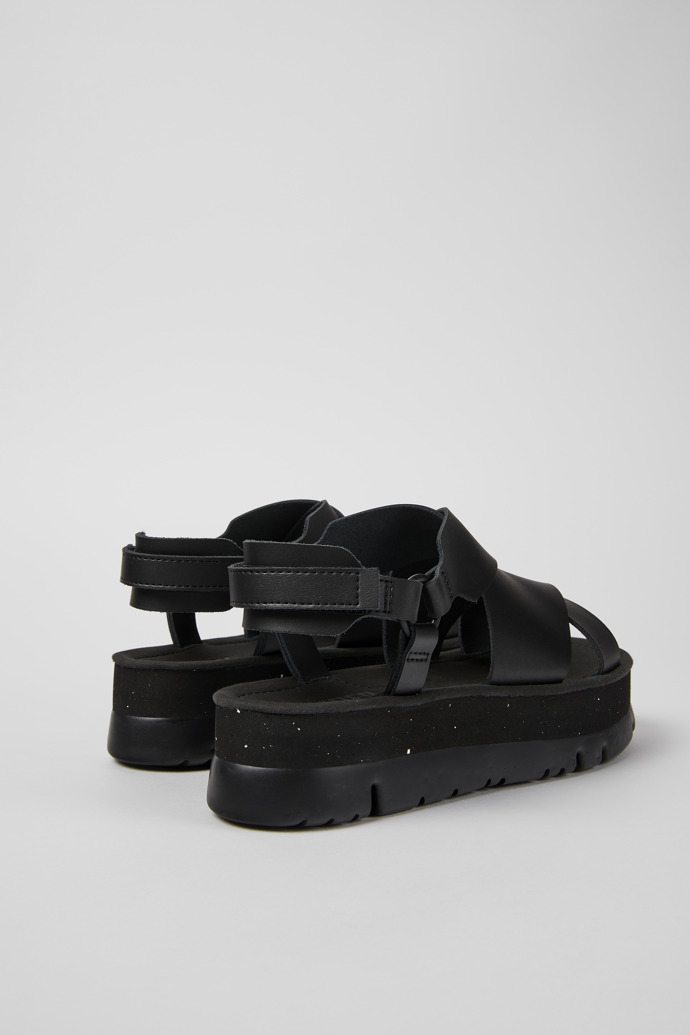 Back view of Oruga Up Black leather sandals for women