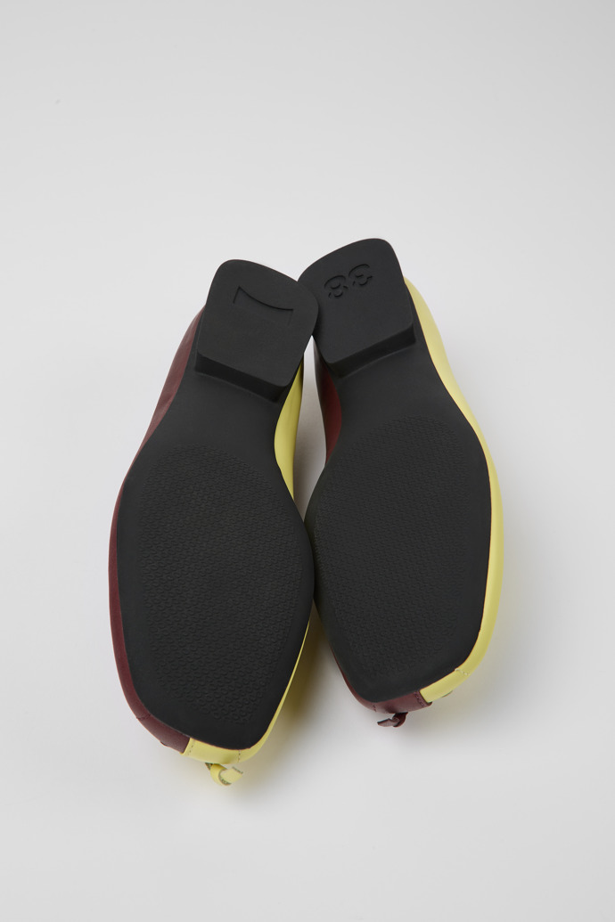 The soles of Twins Yellow and burgundy ballerina flats for women