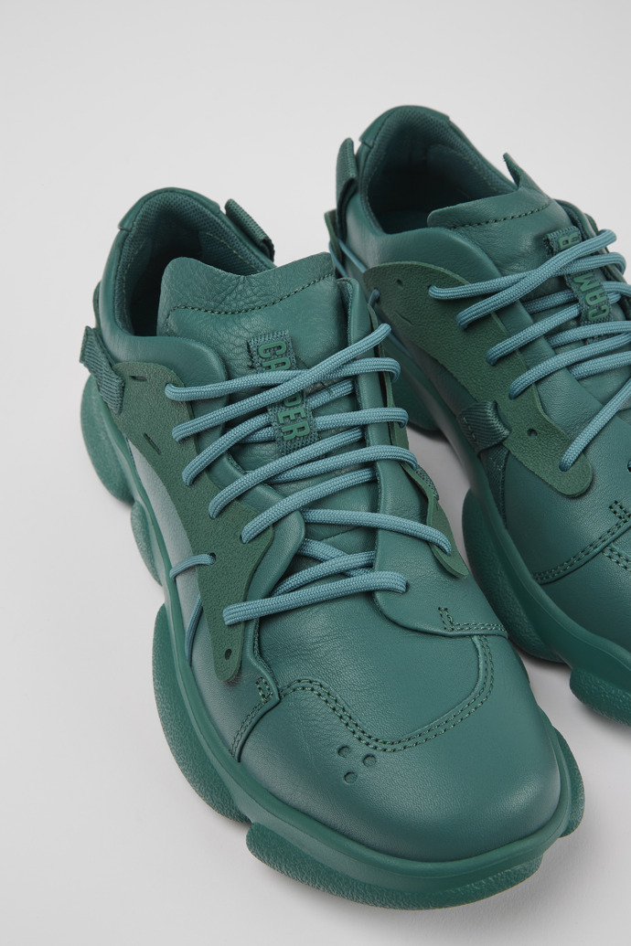 Close-up view of Karst Green leather and textile sneakers for women