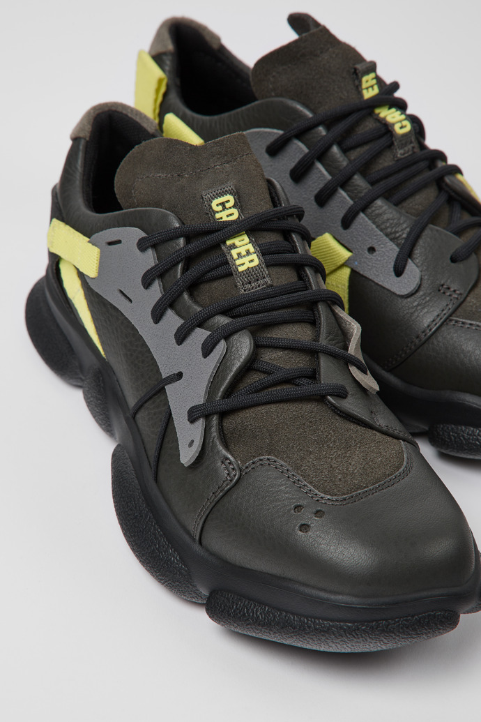 Close-up view of Twins Gray, yellow, and black leather sneakers for women