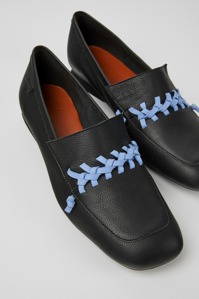Close-up view of Casi Myra Black and blue leather loafers for women