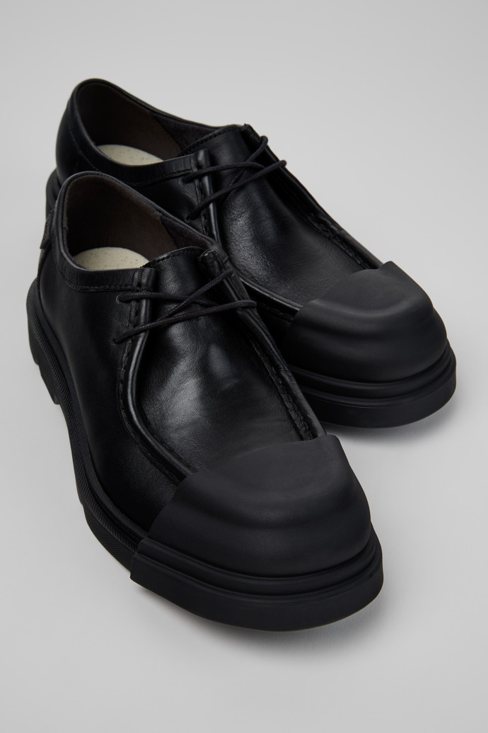 Close-up view of Junction Black Leather Shoes for Women.