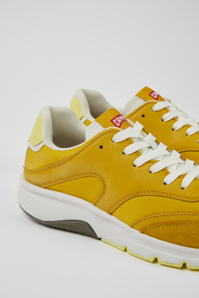Close-up view of Drift Yellow textile and leather sneakers for women