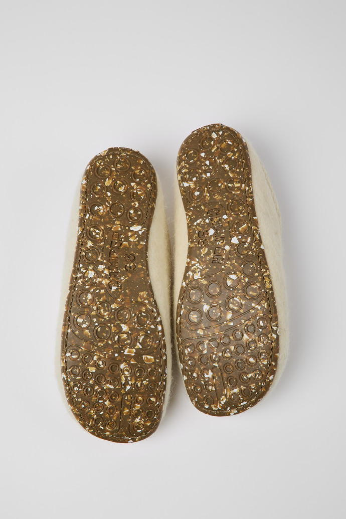 The soles of Wabi Beige wool slippers for women