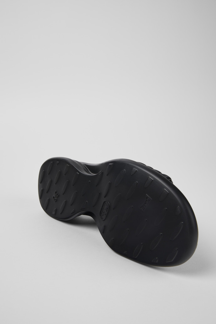 The soles of Spiro Black Leather Cross-strap Sandal for Women