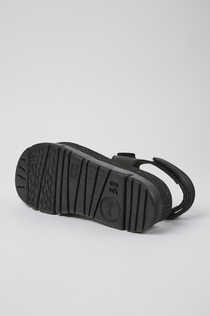 The soles of Oruga Up Black leather sandals for women