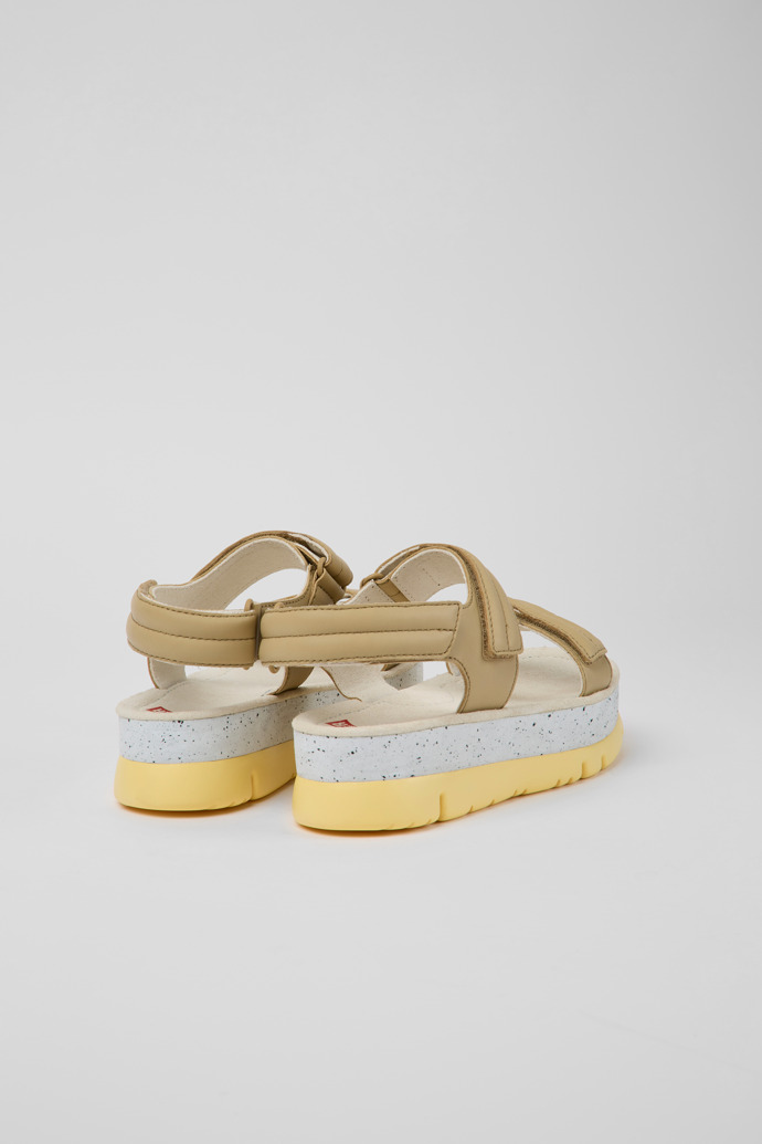 Back view of Oruga Up Beige leather sandals for women