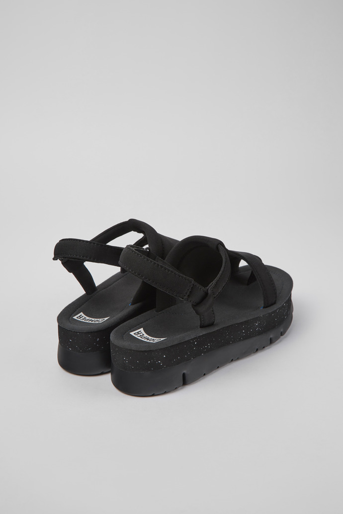 Back view of Oruga Up Black textile sandals for women