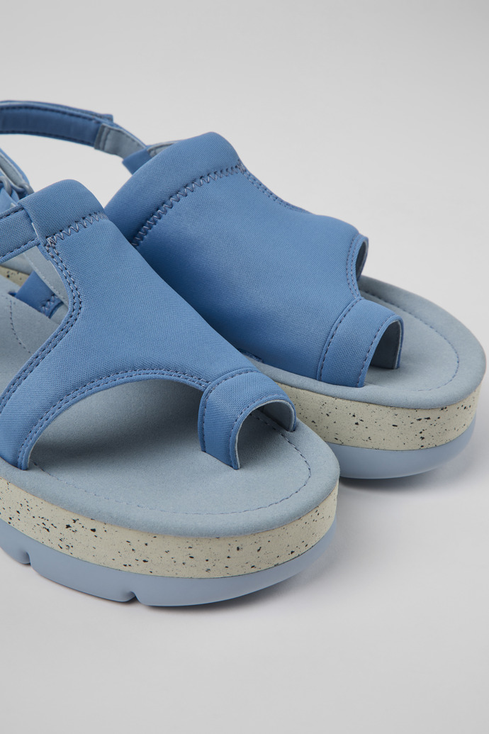 Close-up view of Oruga Up Blue textile sandals for women