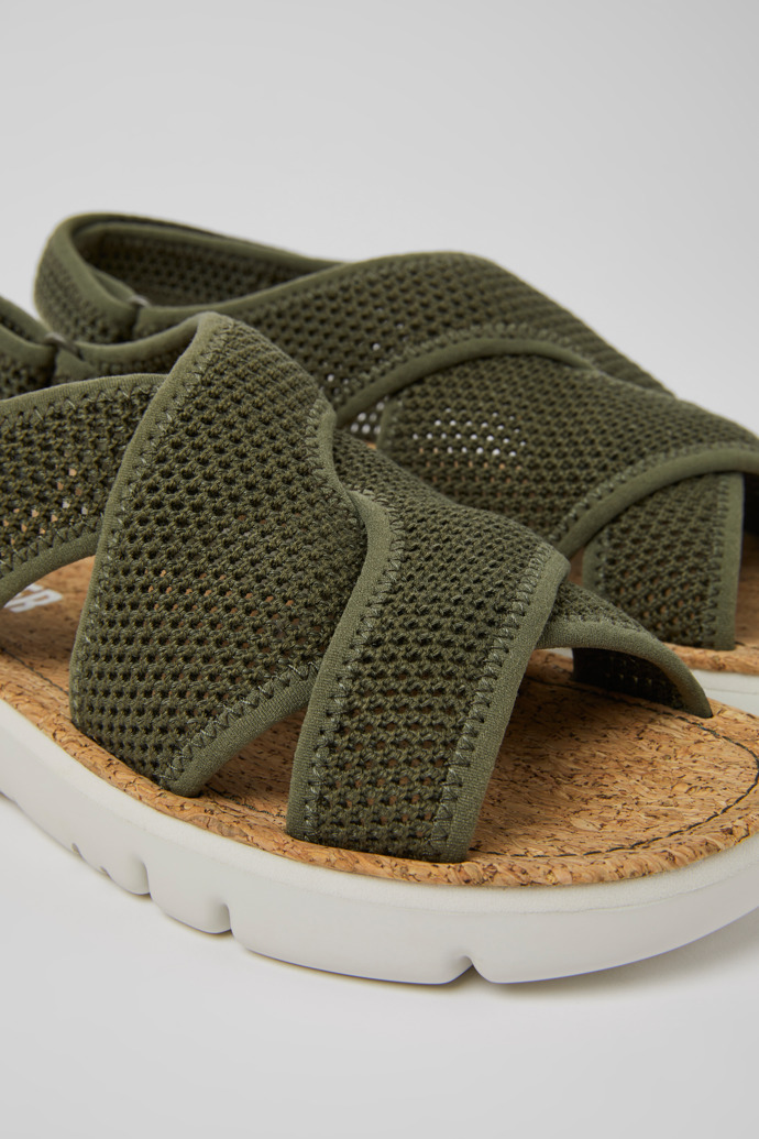 Close-up view of Oruga Green textile sandals for women