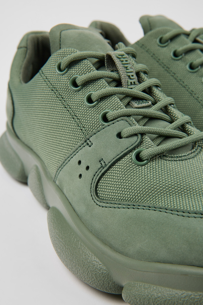 Close-up view of Karst Green leather and recycled PET sneakers for women