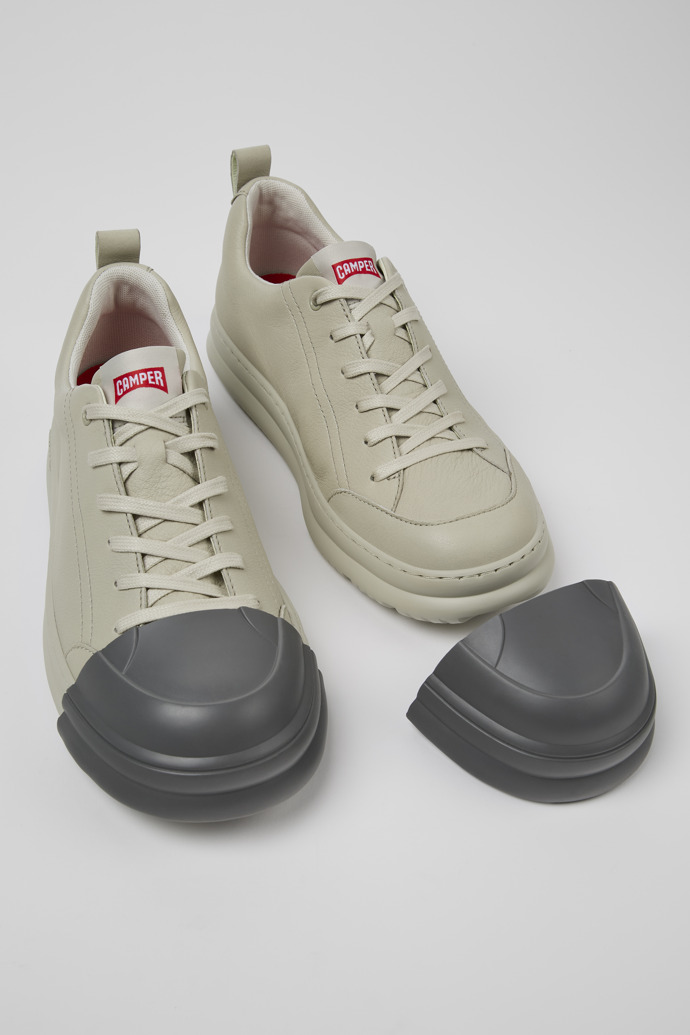 A model wearing Junction Runner Gray leather sneakers for women