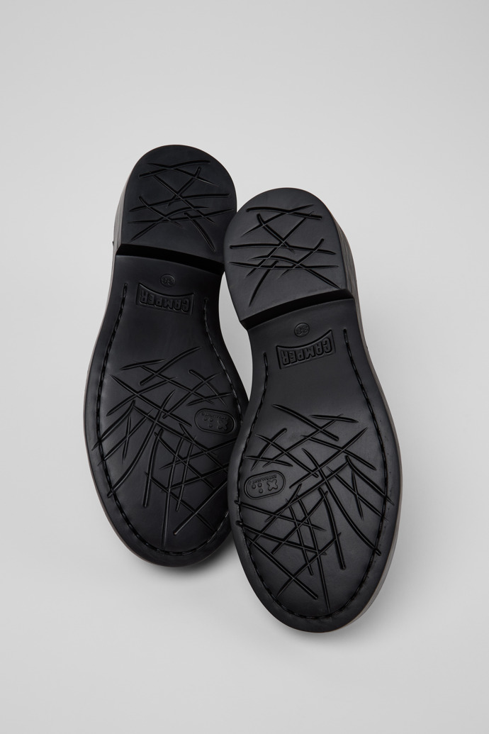 The soles of Dean Black and White Leather Shoes for Women.