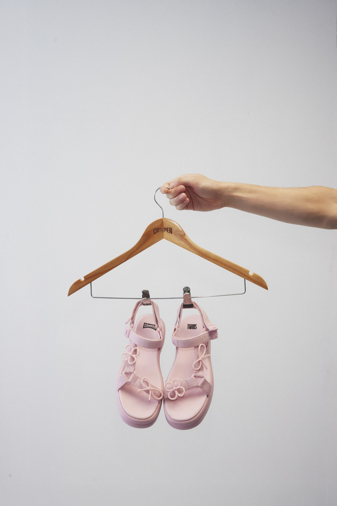 A model wearing Twins Pink Recycled PET Sandals for Women.