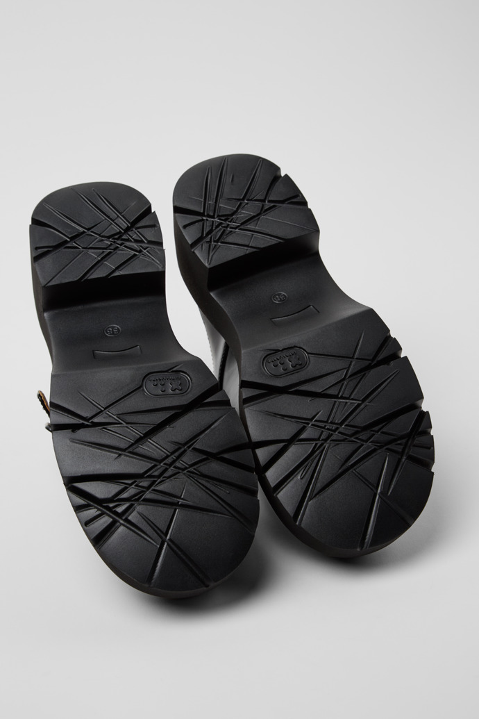 The soles of Milah Black Leather Sandals for Women.