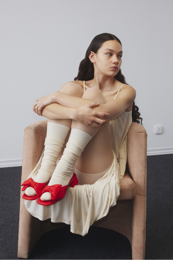 A model wearing Twins Red Recycled PET Women's Sandal.