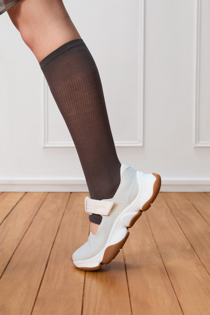 A model wearing Karst 2 White Leather Sneakers for Women.