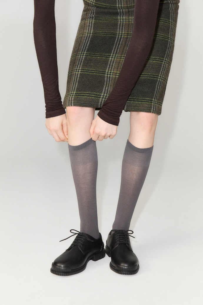 A model wearing Pix Black Leather Shoes for Women.