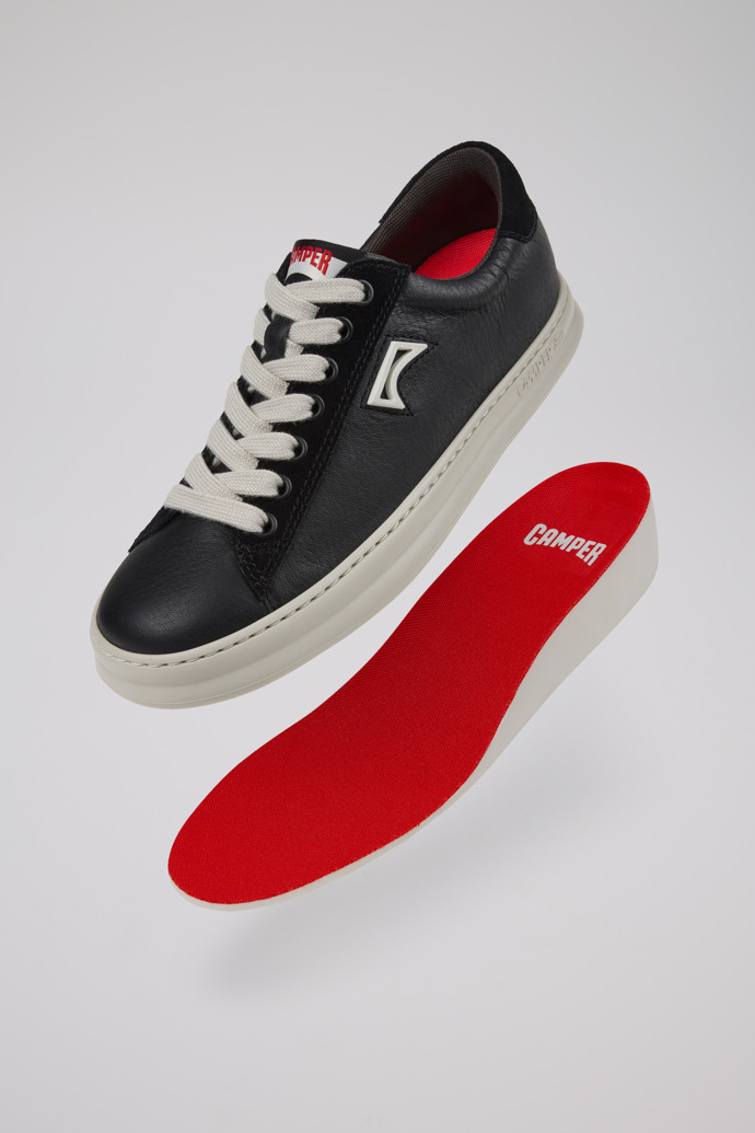 A model wearing Runner Black Leather and Nubuck Sneakers for Women.