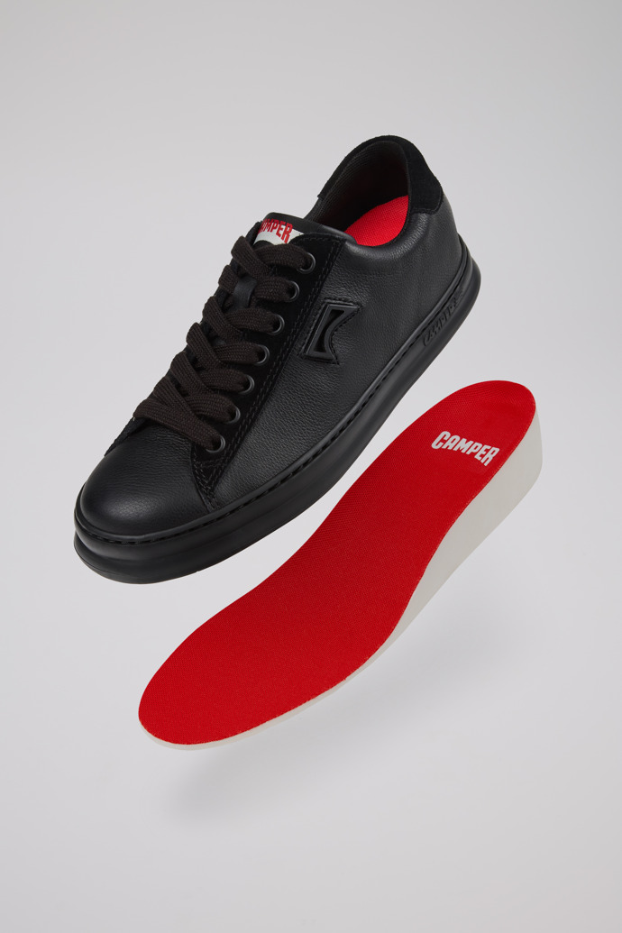 A model wearing Runner Black Leather and Nubuck Sneakers for Women.