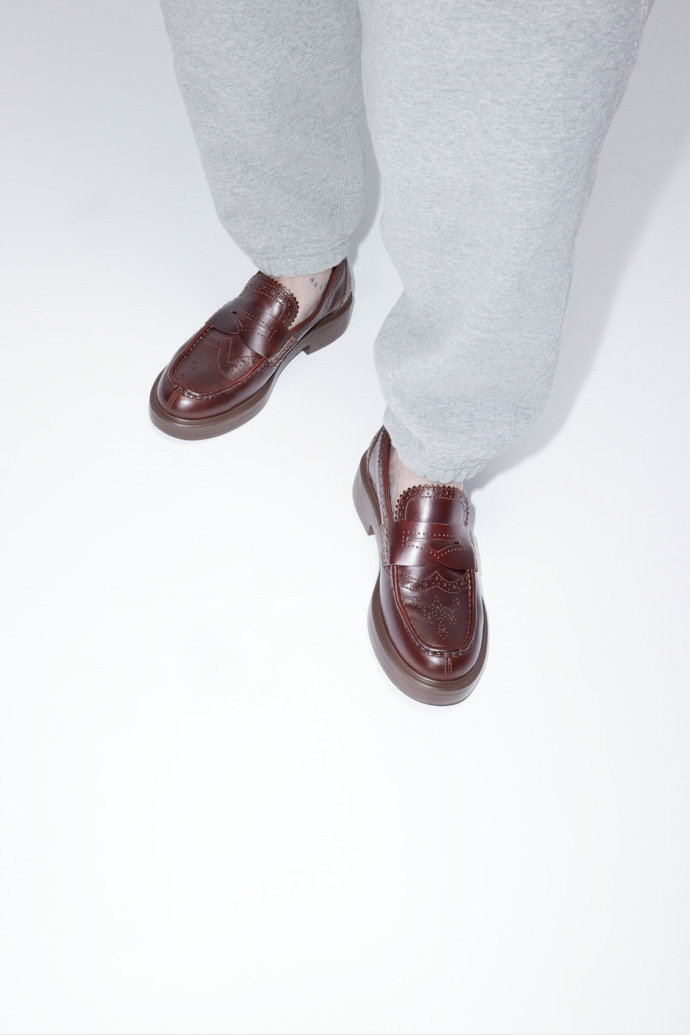 A model wearing Twins Brown Leather Moccasins for Women.