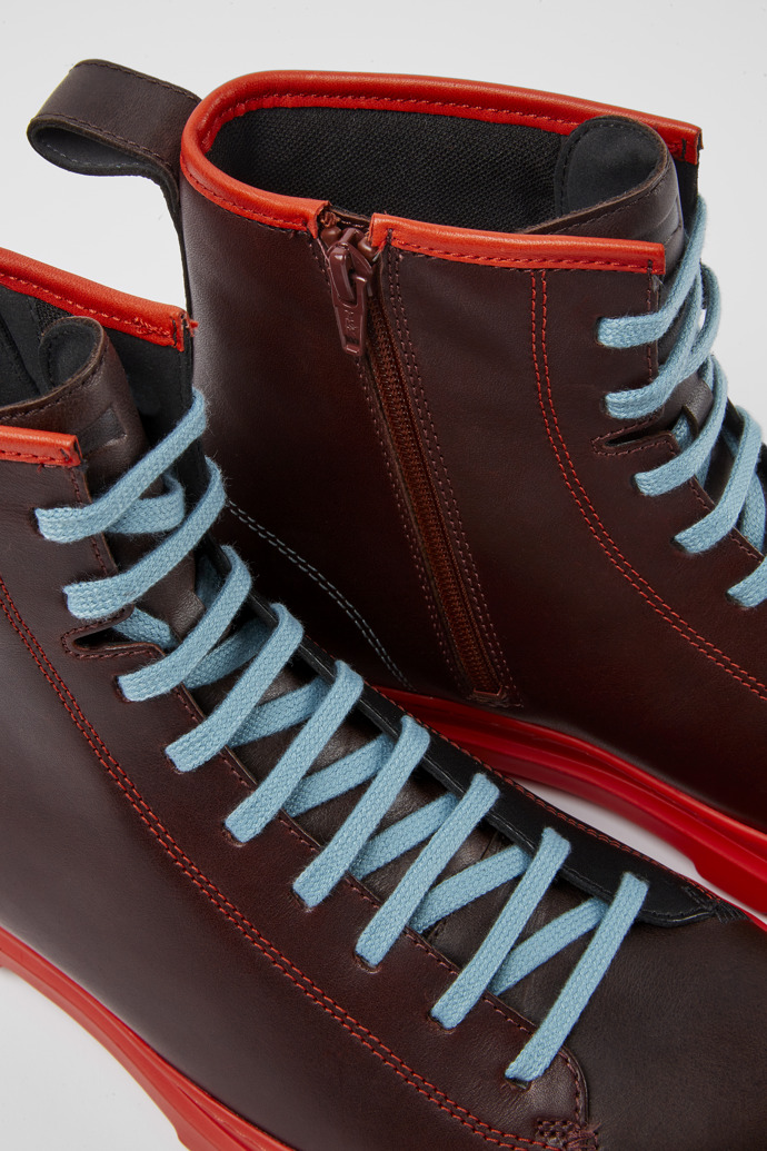 Close-up view of Twins Red, brown and black boots for men