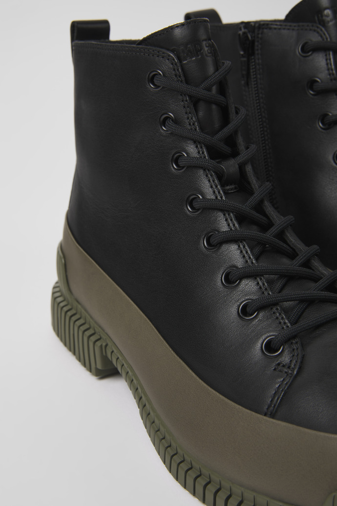 Close-up view of Pix Black and green leather ankle boots for men