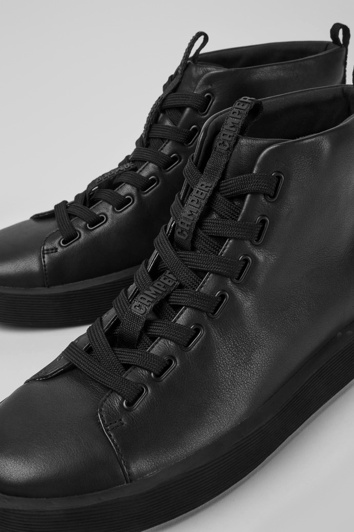 Close-up view of Courb Black leather ankle boots for men