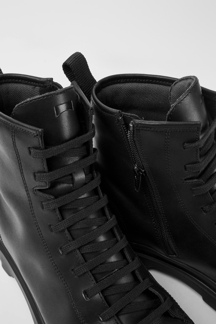 Close-up view of Brutus Black leather lace-up boots
