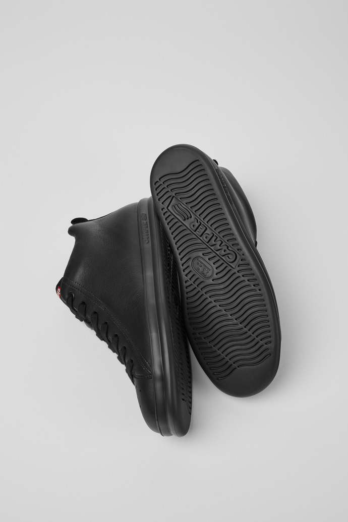 The soles of Runner Black leather sneakers