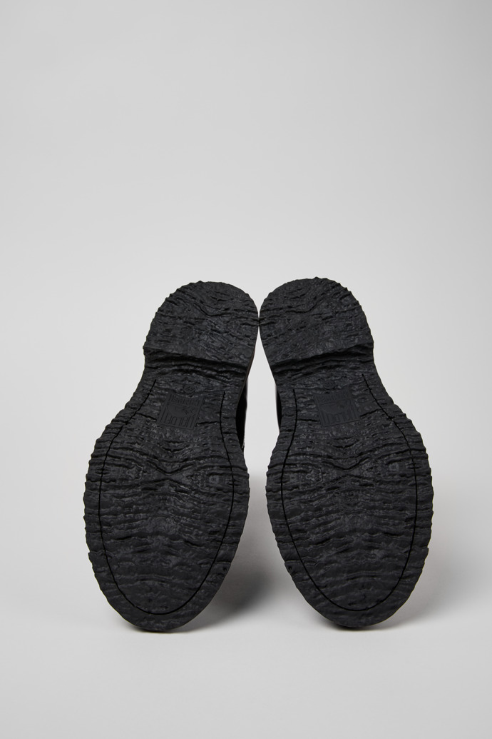 The soles of Walden Black Leather Mid Boots for Men.