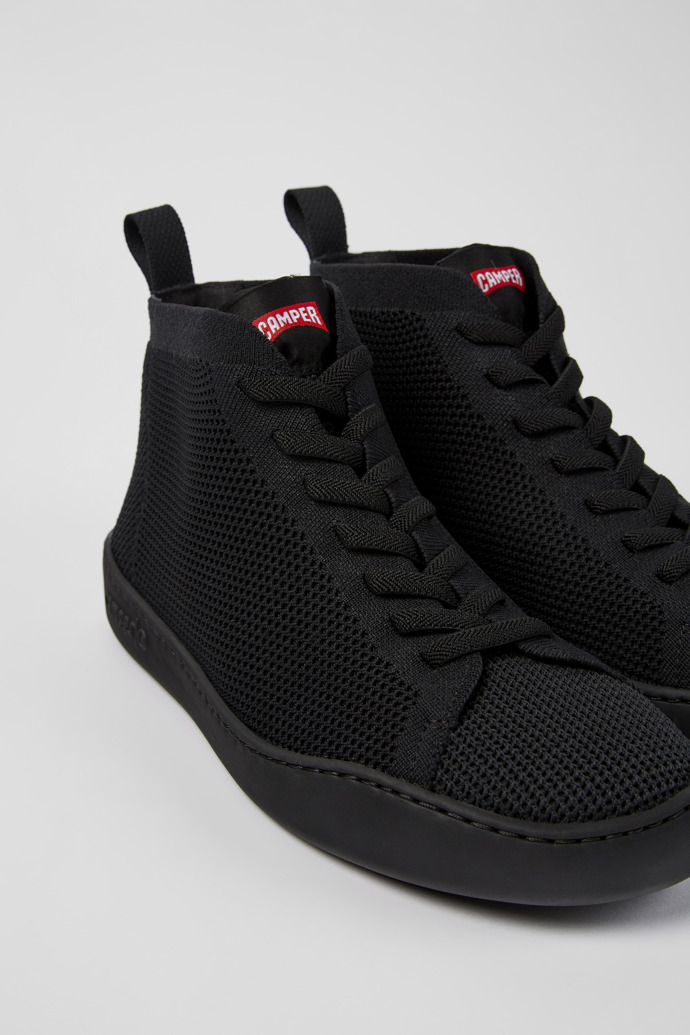 Close-up view of Peu Touring Black one-piece knit sneakers for men