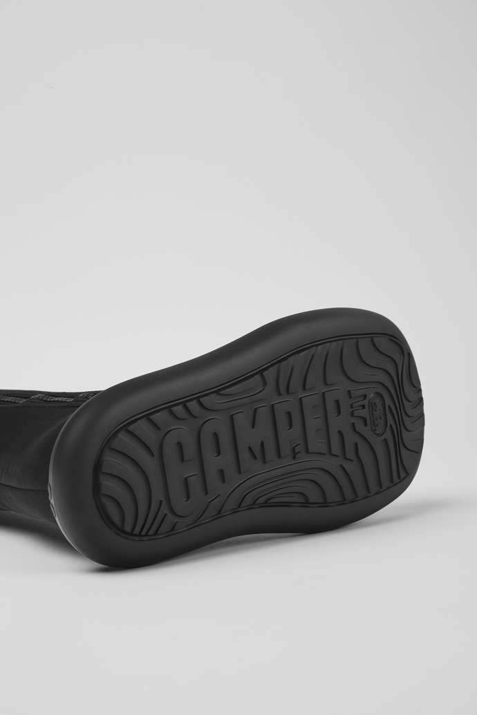 The soles of Ottolinger Black boots for men by Camper x Ottolinger