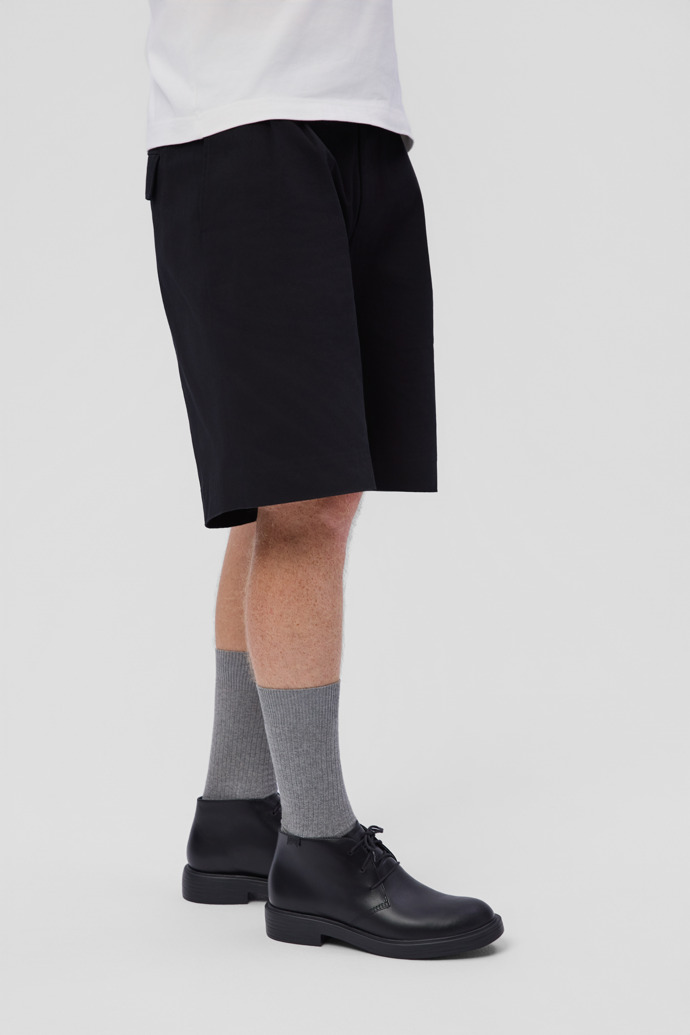 A model wearing Dean Black Leather Ankle Boots for Men.