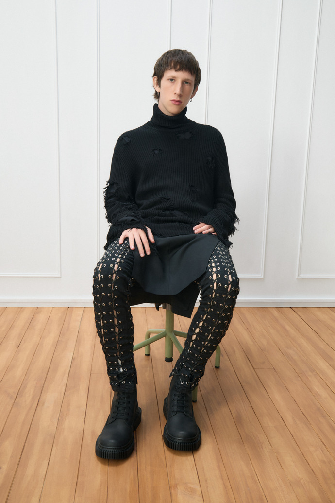 A model wearing Pix Berlin Black Nubuck Mid Boots for Men.
