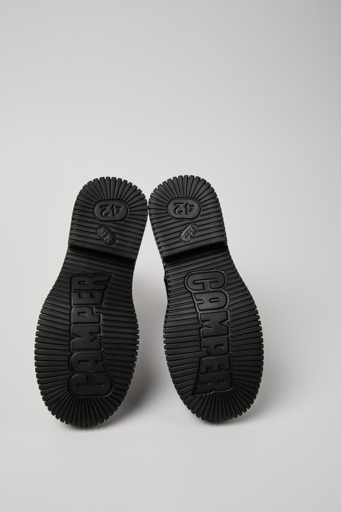 The soles of Pix Berlin Black Leather Mid Boots for Men.